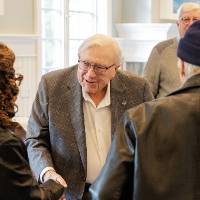 Don Lubbers talking to a couple event guests